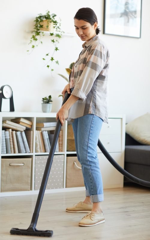 Woman using vacuum cleaner